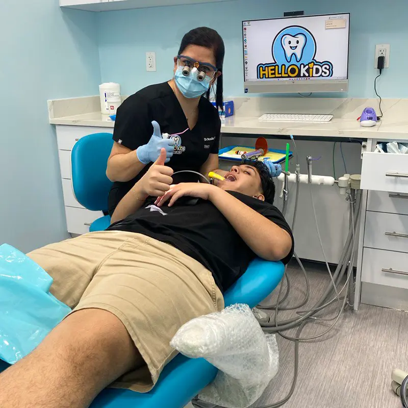 Dr. Roula Yazaji providing gentle dental treatment to a child at Hello Kids Dentistry Kids Dentist Pembroke Pines FL